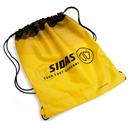 A bright yellow drawstring bag with black cords and a black printed logo reading 'SIDAS YOUR FOOT COMPANY' on a white background.